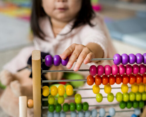 Little girl playing abacus for counting practice